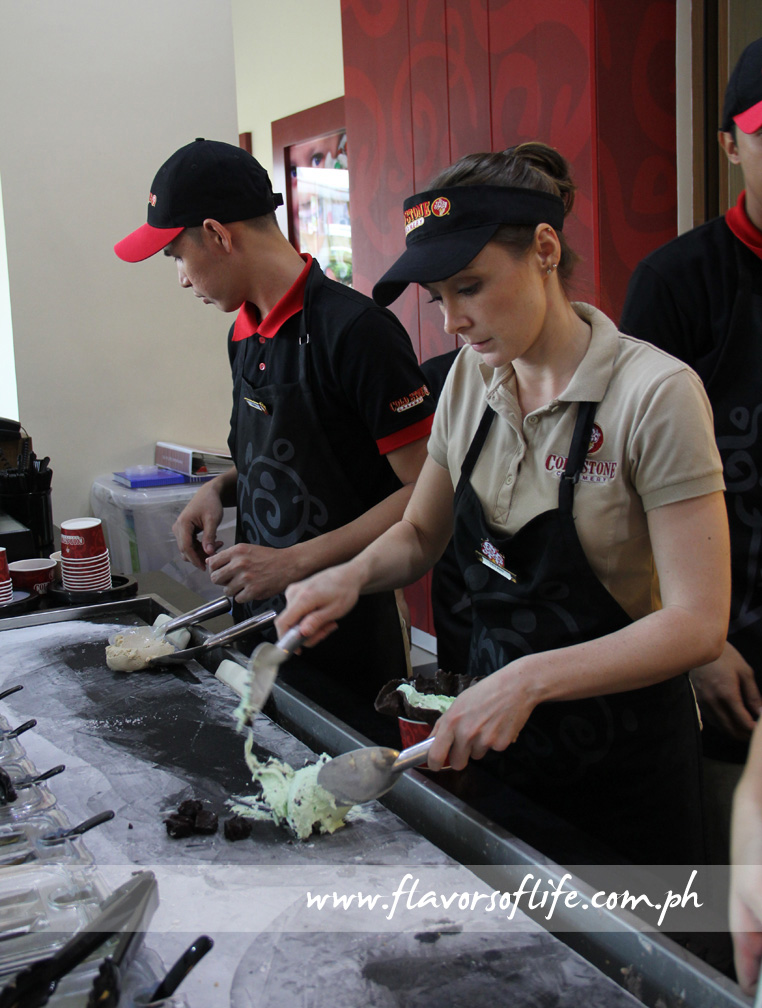 Cold Stone crew member mixing up ice cream and mix-ins on a 15ºF cold stone
