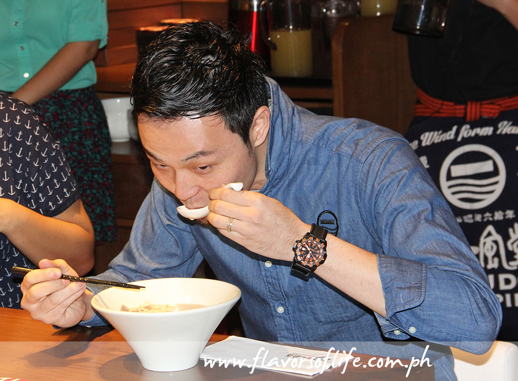 Shiiba showing how best to enjoy a bowl of Japanese ramen: Sip the soup, pick up a few strands of noodles and slurp, then take the toppings